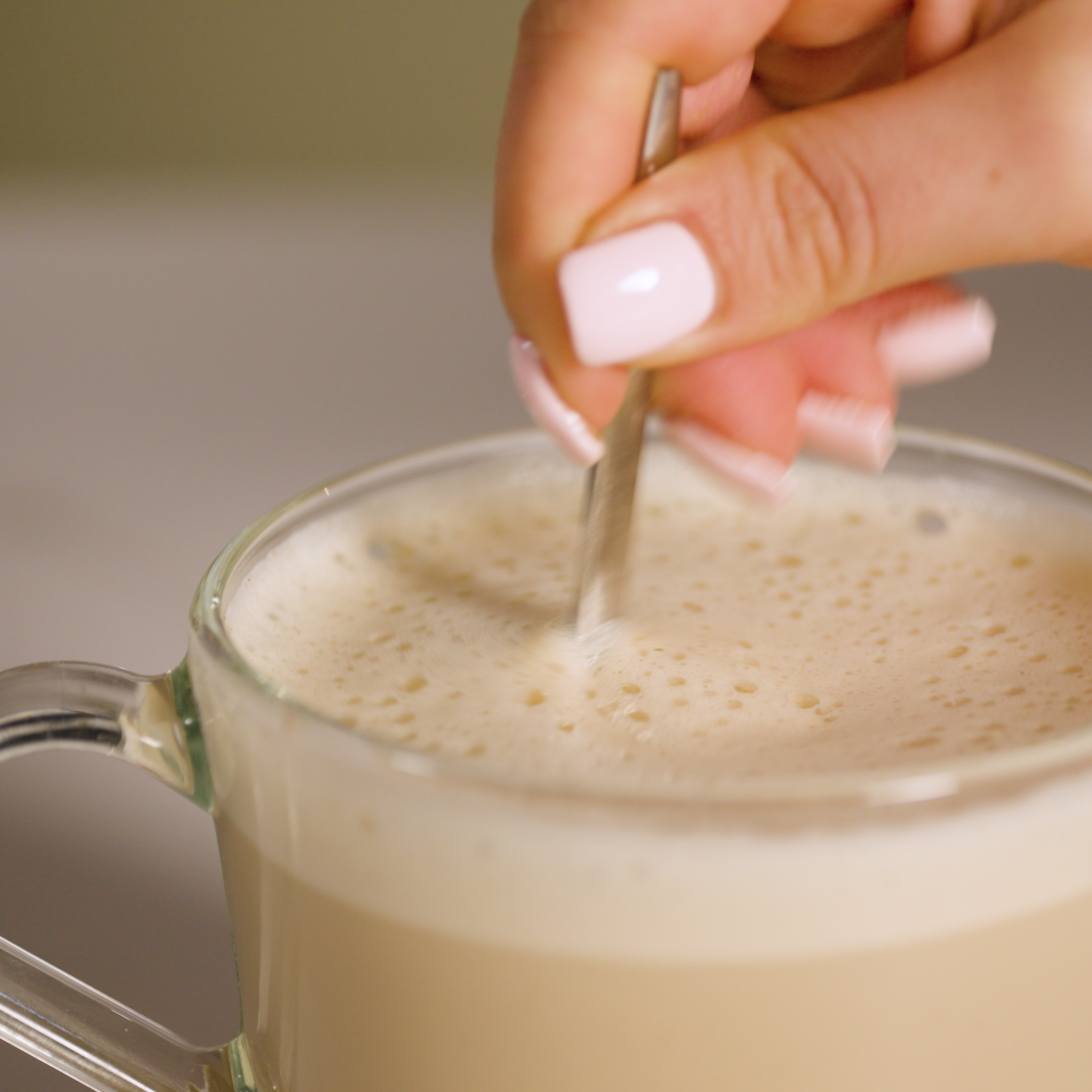 how to make - chai latte being stirred