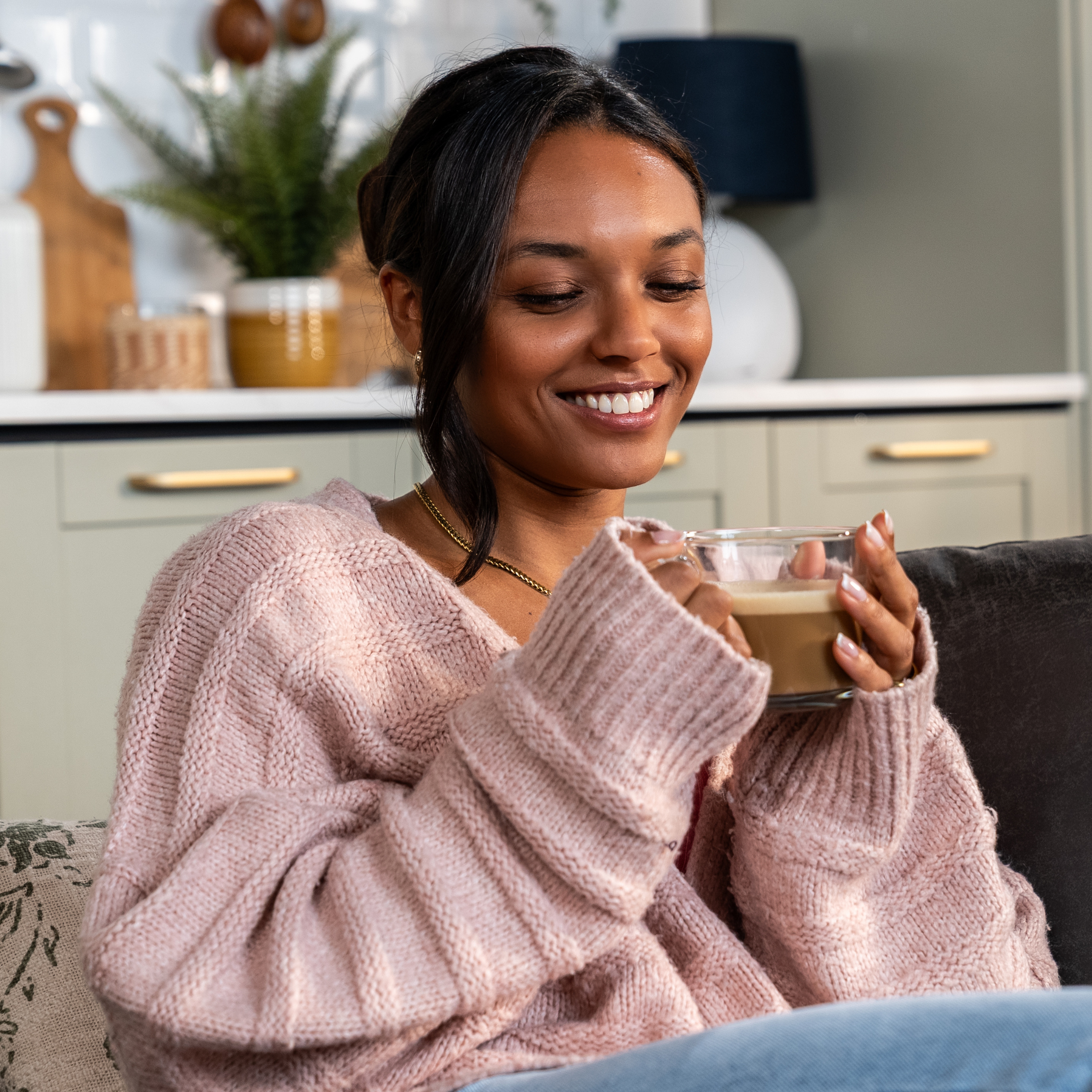 lady enjoying spiced chai latte while sat on sofa